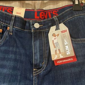New Levi's slim from hip through thigh, hits at the knee.